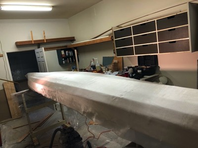  Fiberglass cloth is smoothed on the hull. 
