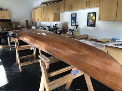  The first coat of varnish is applied to the hull.  