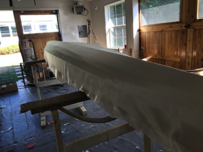  Fiberglass cloth is laid out on the hull. 
