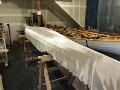  4/6/20 - Fiberglass cloth is laid on the hull. 