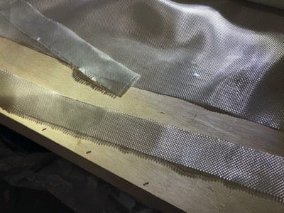  Fiberglass tape is cut from a roll. 