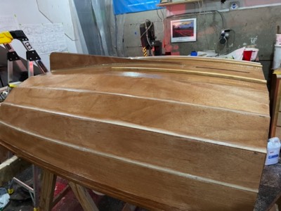  10/11/21 - The outside of the hull is given a seat coat of epoxy. 