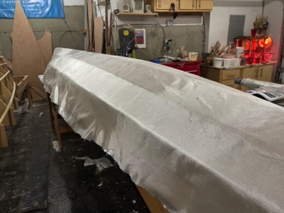  11/24/21 - Fiberglas cloth is laid on the hull.  