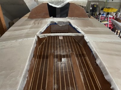  7/8/21 - Fiberglass cloth is laid on the cockpit seats. 