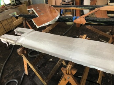  Fiberglass is laid out on one side of the keel. 