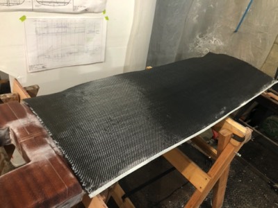  7/3/20 - Carbon fiber cloth is laid onto the keel. 