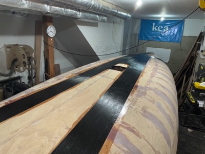  12/7/20 - Unidirectional carbon fiber is epoxied to the hull to increase the hull stifness.  