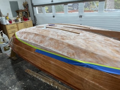  The varnish is sanded off in the area where bottom paint will be applied. 