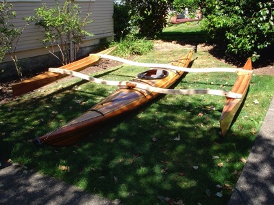  After holes are drilled for bolts in the amas they are put together and laid on the kayak. 