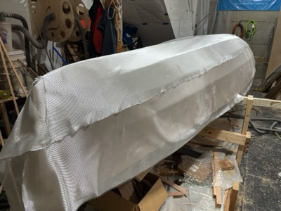  Fiberglass cloth is laid on the hull.  